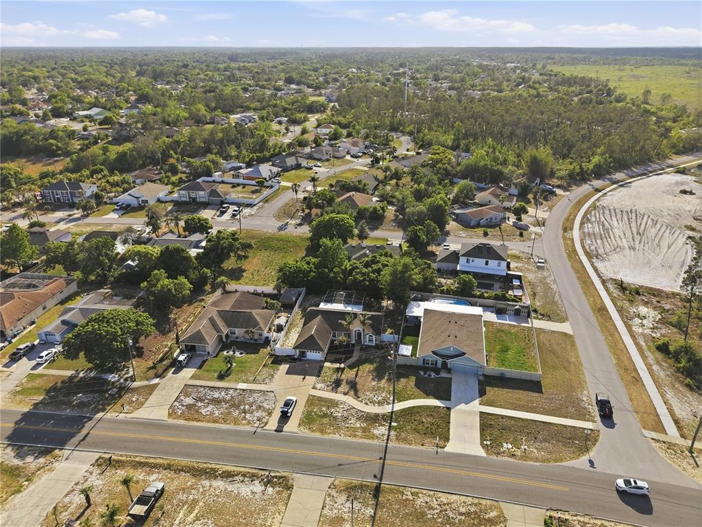 5277 Deltona Boulevard Spring Hill, FL 34606 - Photo 60 of 74 an aerial view of residential houses with outdoor space