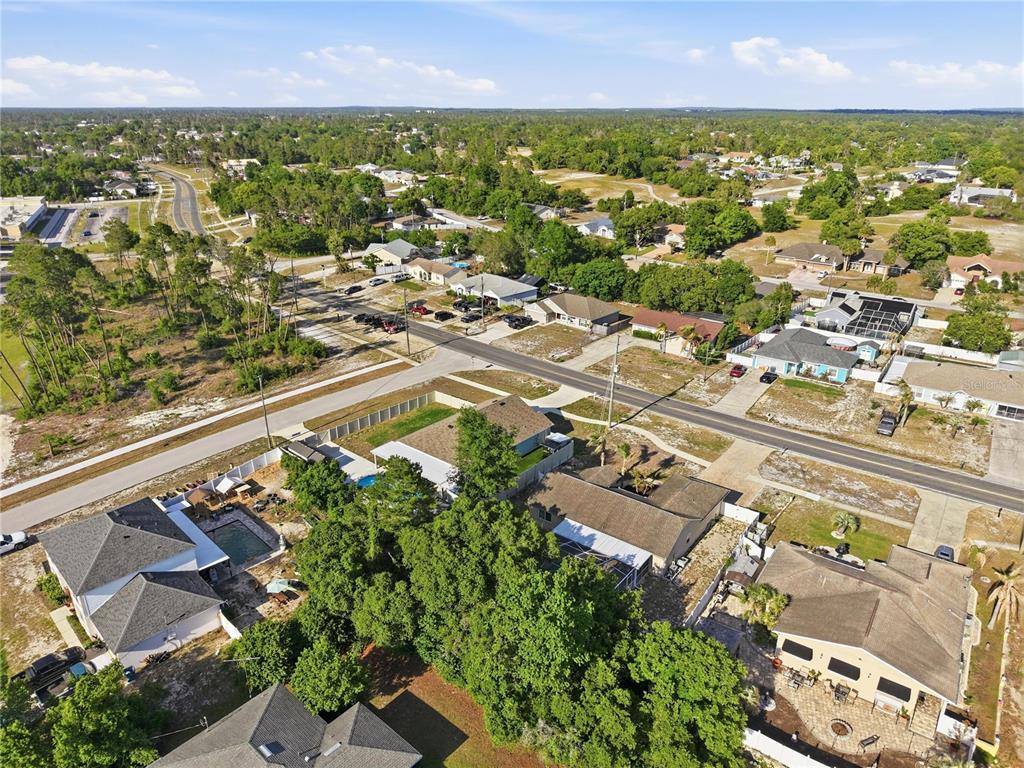 5277 Deltona Boulevard Spring Hill, FL 34606 - Photo 61 of 74 an aerial view of residential houses with outdoor space