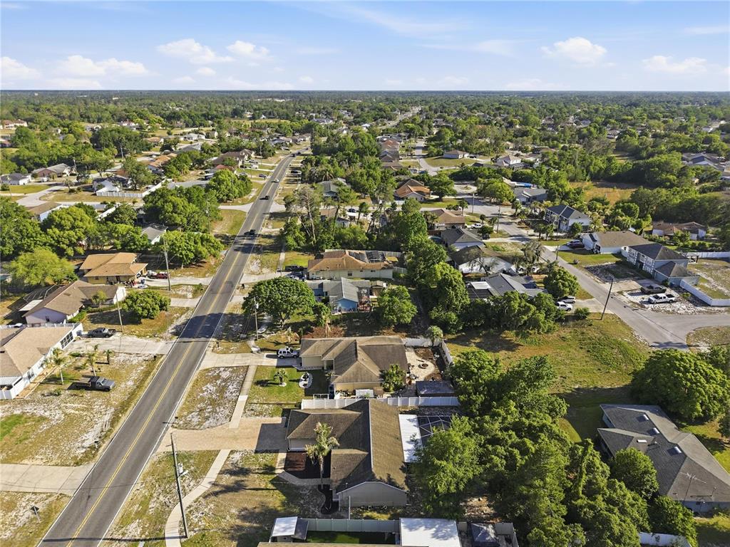 5277 Deltona Boulevard Spring Hill, FL 34606 - Photo 69 of 74 an aerial view of residential houses with outdoor space and trees