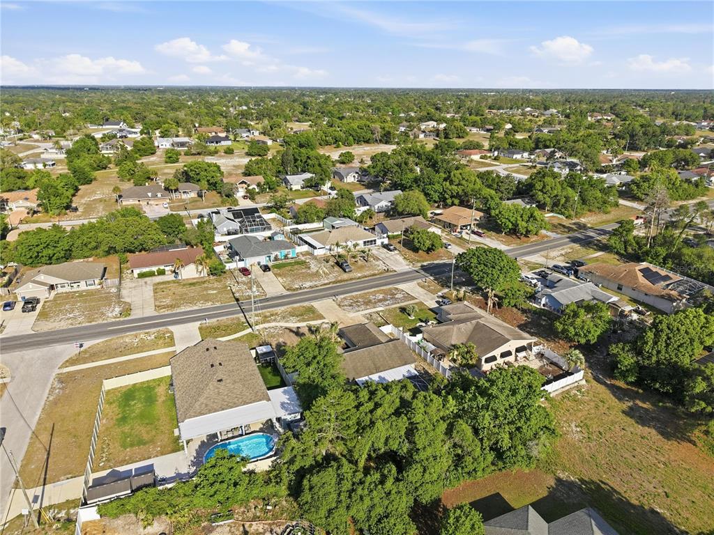 5277 Deltona Boulevard Spring Hill, FL 34606 - Photo 70 of 74 an aerial view of residential houses with outdoor space and trees
