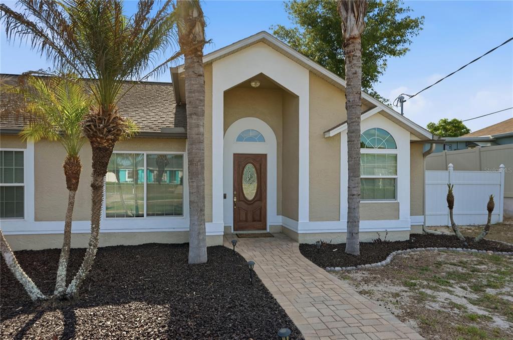 5277 Deltona Boulevard Spring Hill, FL 34606 - Photo 73 of 74 a front view of a house with garden