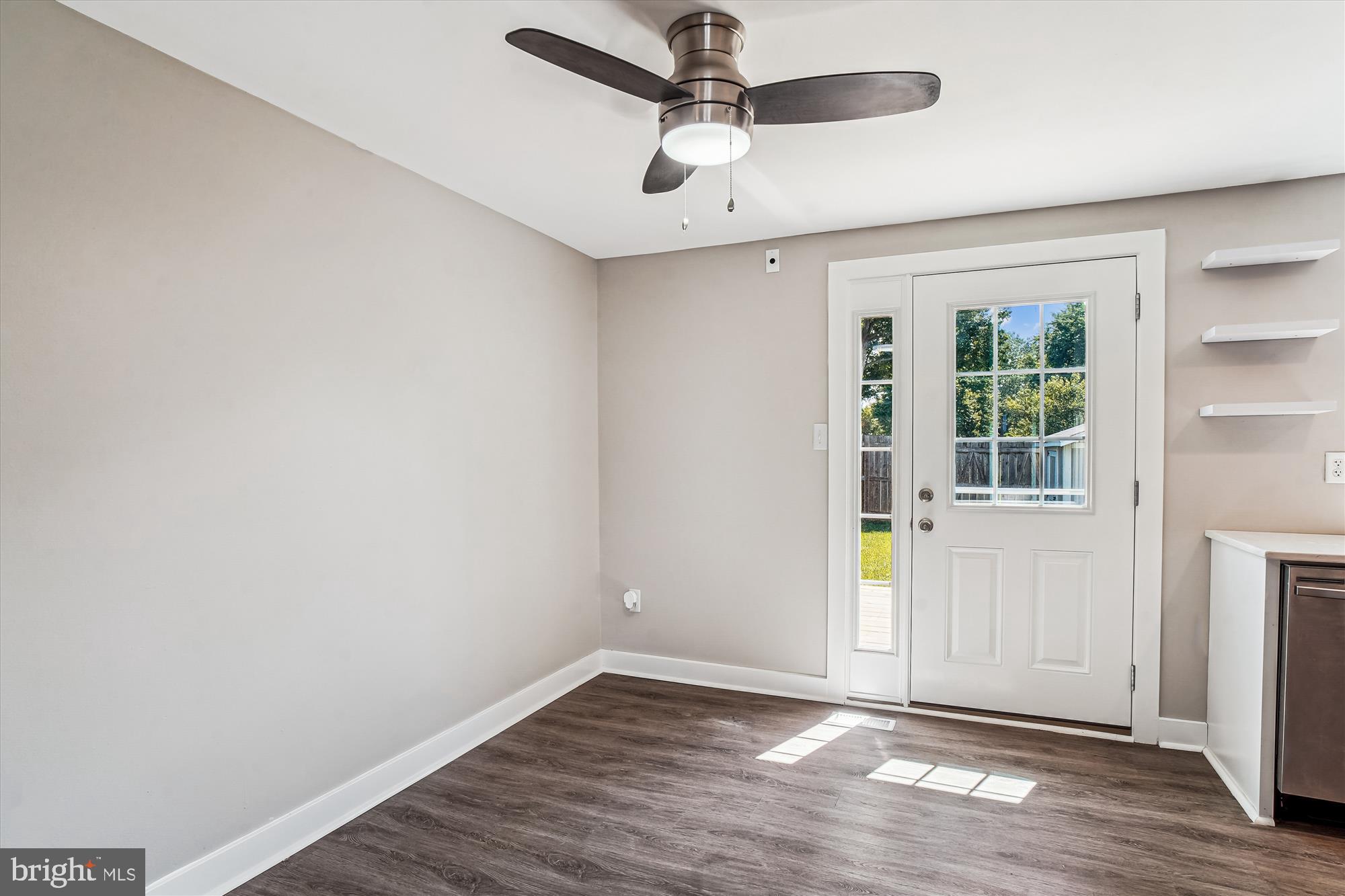 1708 Heather Lane Frederick, MD 21702 - Photo 17 of 47 an empty room with wooden floor chandelier fan and windows