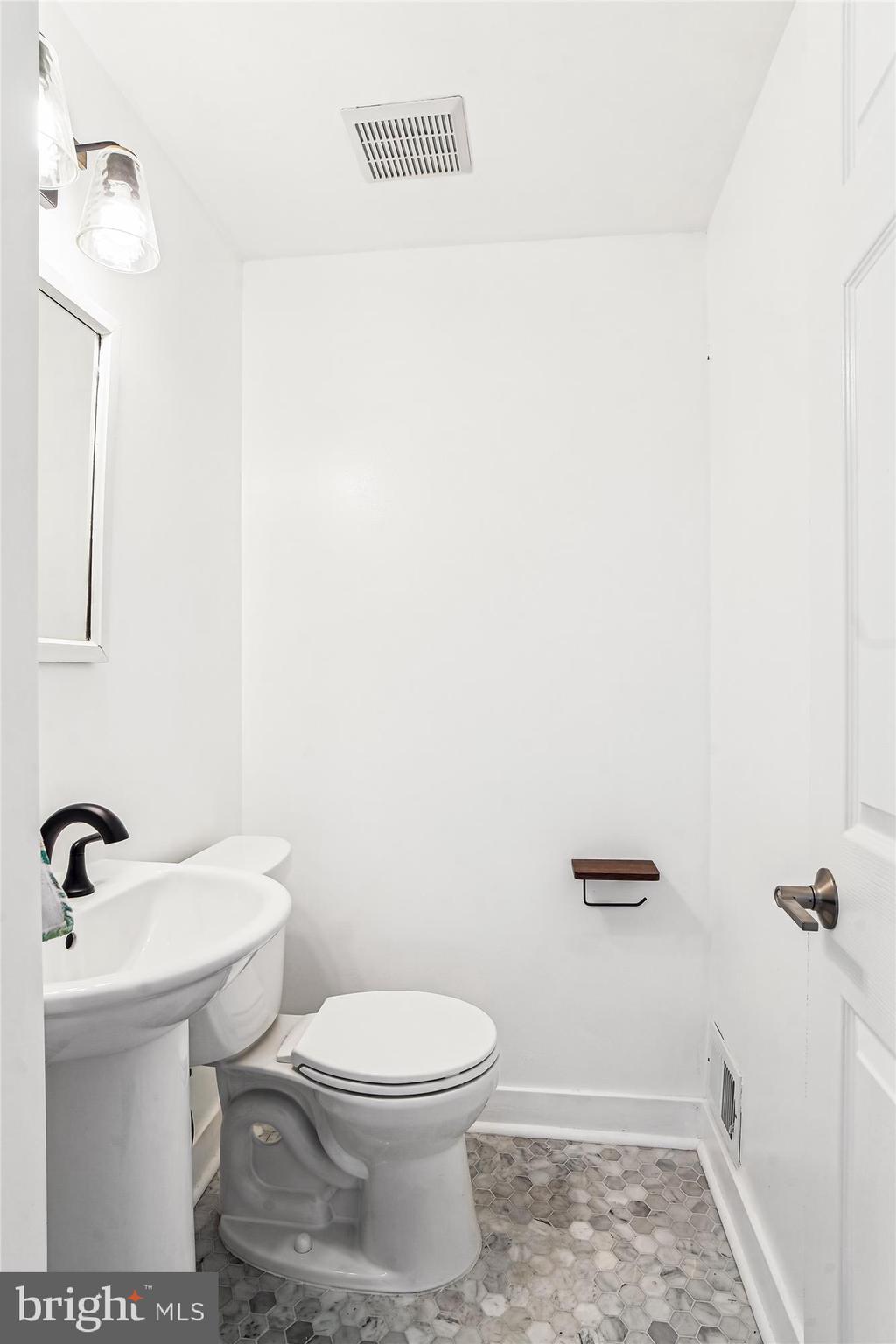 1708 Heather Lane Frederick, MD 21702 - Photo 19 of 47 a bathroom with a sink a toilet and mirror