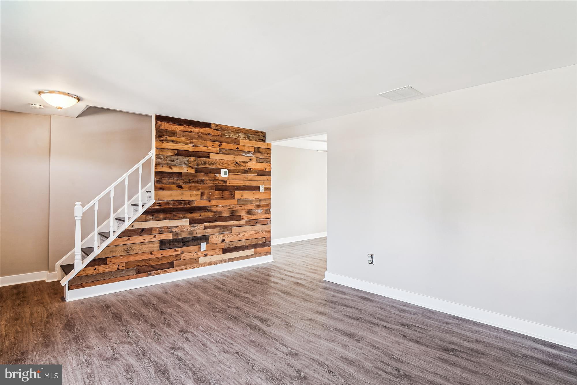 1708 Heather Lane Frederick, MD 21702 - Photo 10 of 47 a view of an empty room with wooden floor and stairs