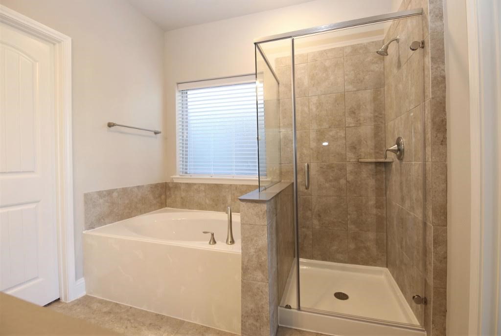 8202 Aleppo Pine Lane Cypress, TX 77433 - Photo 18 of 31 a white bath tub sitting next to a shower