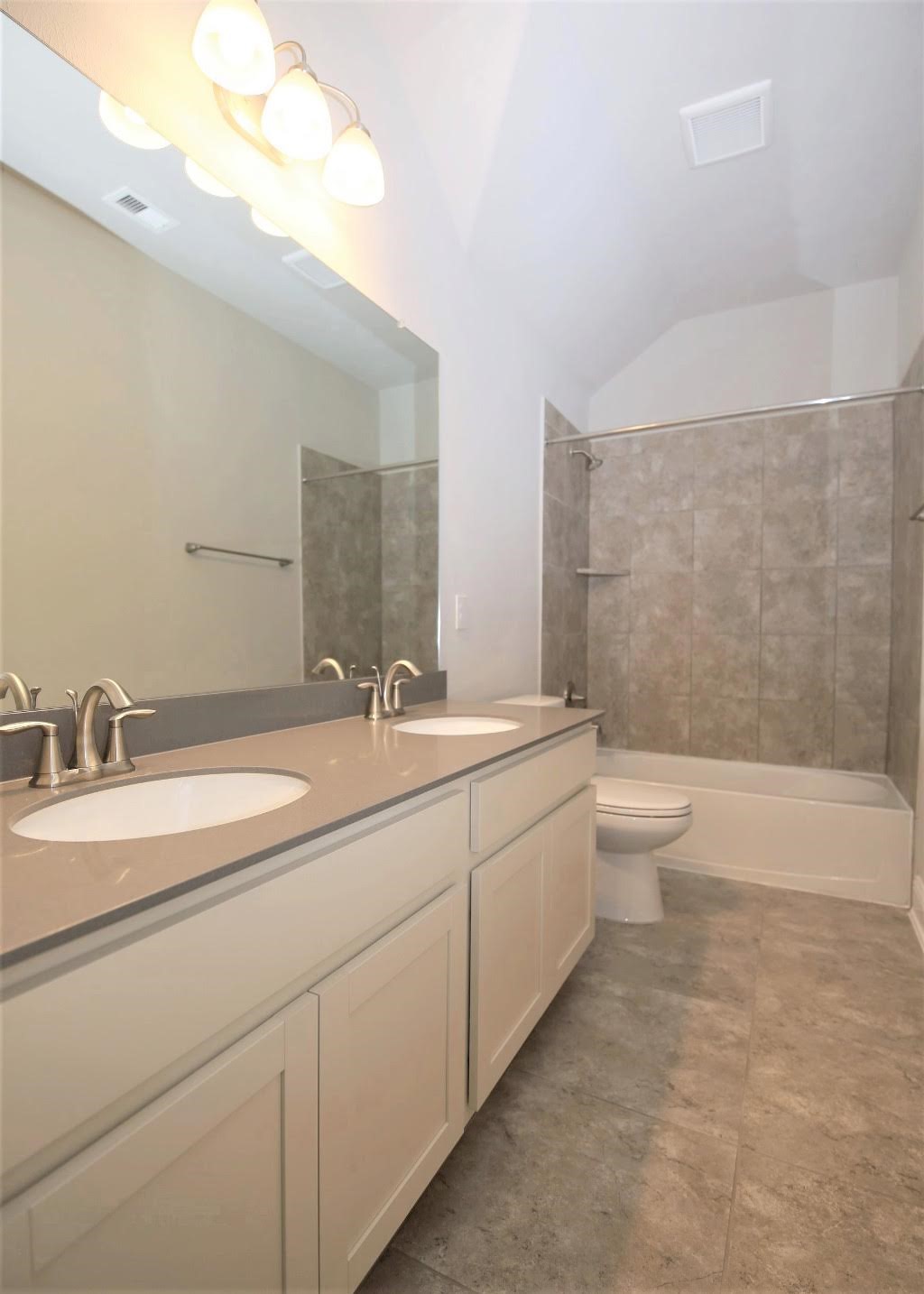 8202 Aleppo Pine Lane Cypress, TX 77433 - Photo 21 of 31 a bathroom with a double vanity sink a toilet and a bathtub