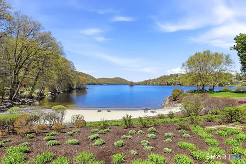 a view of a lake with houses in the back