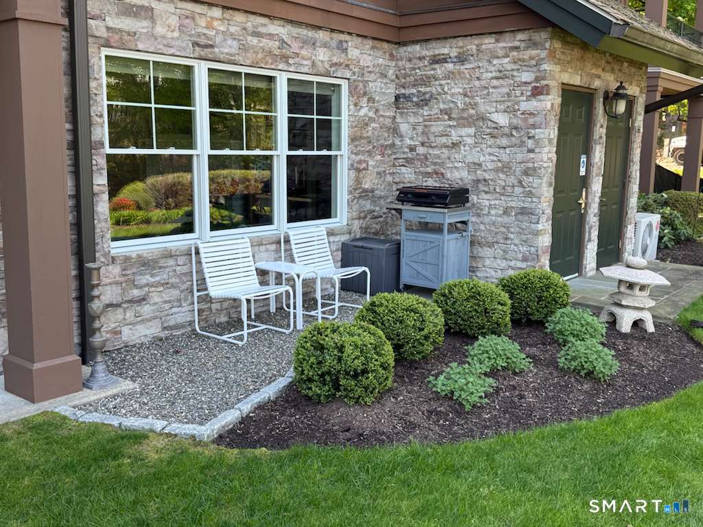 16 Hayestown Road, Unit D102 Danbury, CT 06811 - Photo 24 of 29 a view of a chair and table in backyard of the house