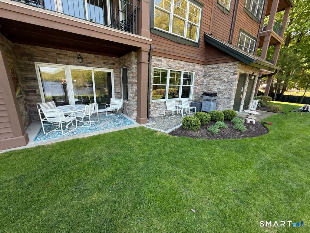 16 Hayestown Road, Unit D102 Danbury, CT 06811 - Photo 25 of 29 a view of a chair and table in backyard of the house