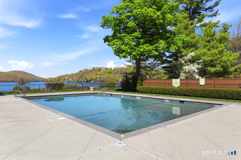16 Hayestown Road, Unit D102 Danbury, CT 06811 - Photo 27 of 29 a view of swimming pool with outdoor seating and plants