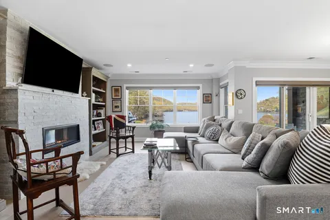 a living room with fireplace furniture and a flat screen tv