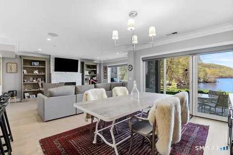 a living room with furniture a large window and a flat screen tv