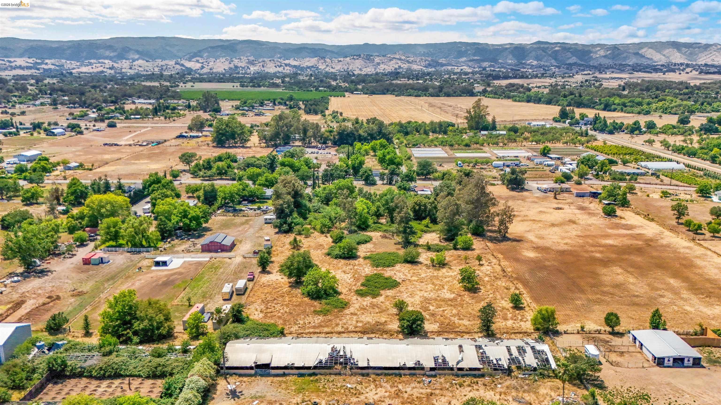 7750 Locke Road Vacaville, CA 95688 - Photo 3 of 23 Expansive rural landscape featuring a mix of agricultural fields and mature trees