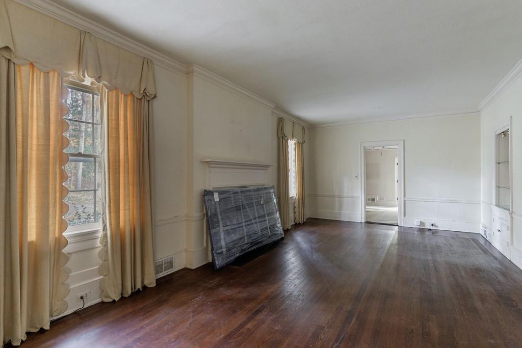 3990 Randall Mill Road Northwest Atlanta, GA 30327 - Photo 28 of 65 an empty room with wooden floor cabinet and front door