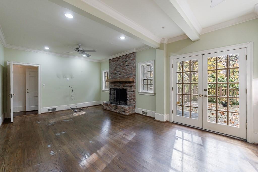3990 Randall Mill Road Northwest Atlanta, GA 30327 - Photo 38 of 65 a view of a livingroom with wooden floor and a fireplace