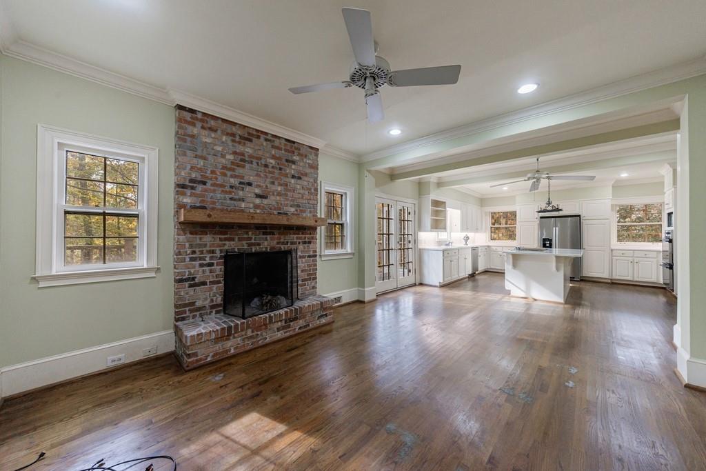 3990 Randall Mill Road Northwest Atlanta, GA 30327 - Photo 39 of 65 a view of a livingroom with wooden floor a fireplace and window