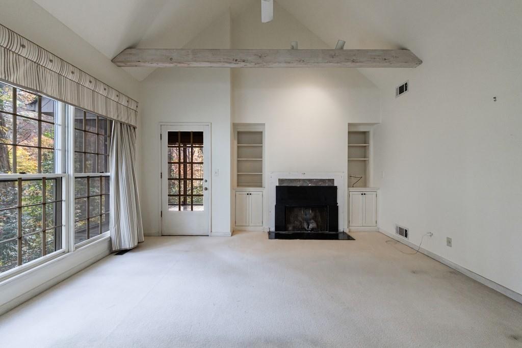 3990 Randall Mill Road Northwest Atlanta, GA 30327 - Photo 42 of 65 a view of an empty room with a fireplace and a window
