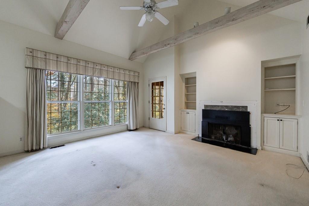 3990 Randall Mill Road Northwest Atlanta, GA 30327 - Photo 43 of 65 a view of an empty room with a fireplace and a window