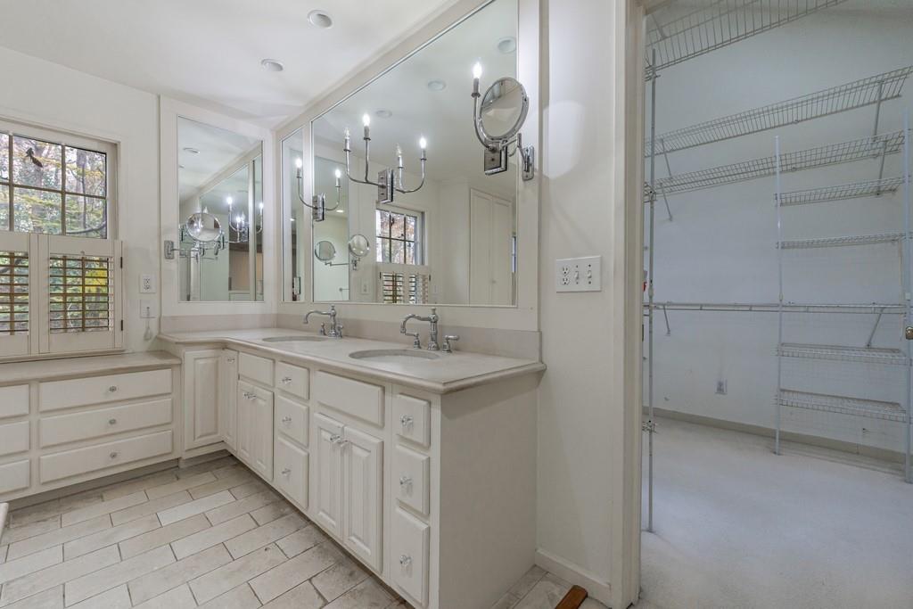 3990 Randall Mill Road Northwest Atlanta, GA 30327 - Photo 46 of 65 a bathroom with a double vanity sink a mirror and a shower