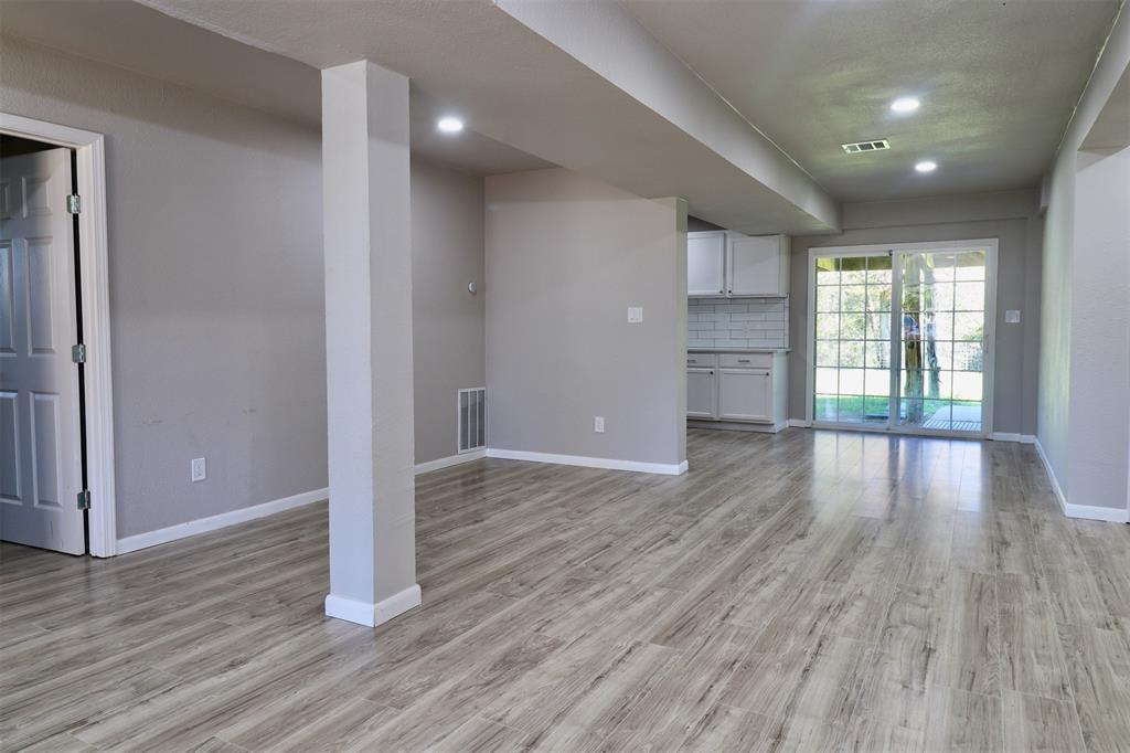 11400 Lakeview Circle Brenham, TX 77833 - Photo 3 of 9 a view of an empty room with wooden floor and a window