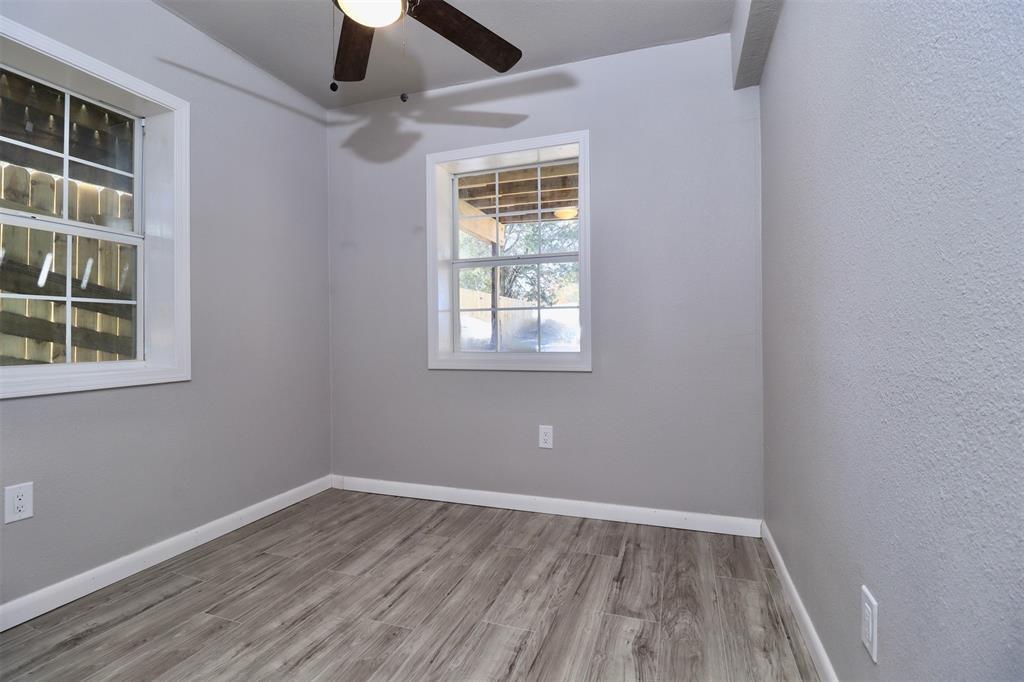 11400 Lakeview Circle Brenham, TX 77833 - Photo 7 of 9 an empty room with a window and wooden floor