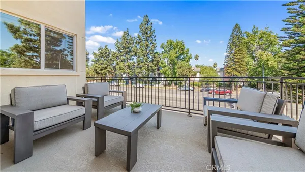 a view of a terrace with couches and wooden floor