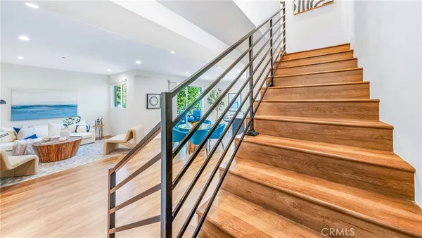 a view of entryway and hall with wooden floor