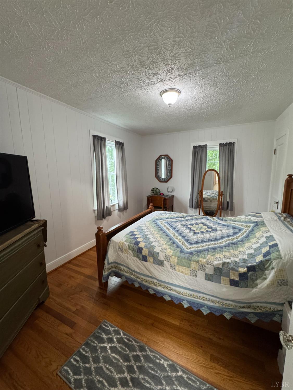 100 New Chapel Road Rustburg, VA 24588 - Photo 22 of 44 a bedroom with a bed and wooden floor