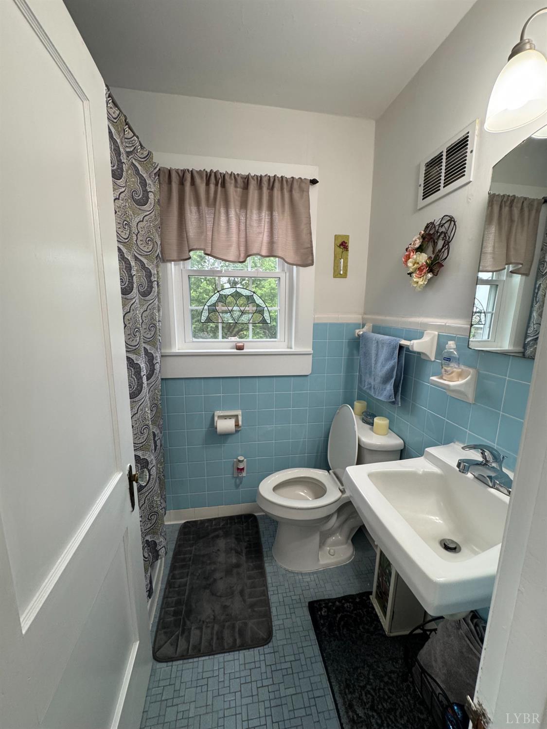 100 New Chapel Road Rustburg, VA 24588 - Photo 23 of 44 a bathroom with a sink toilet and a window