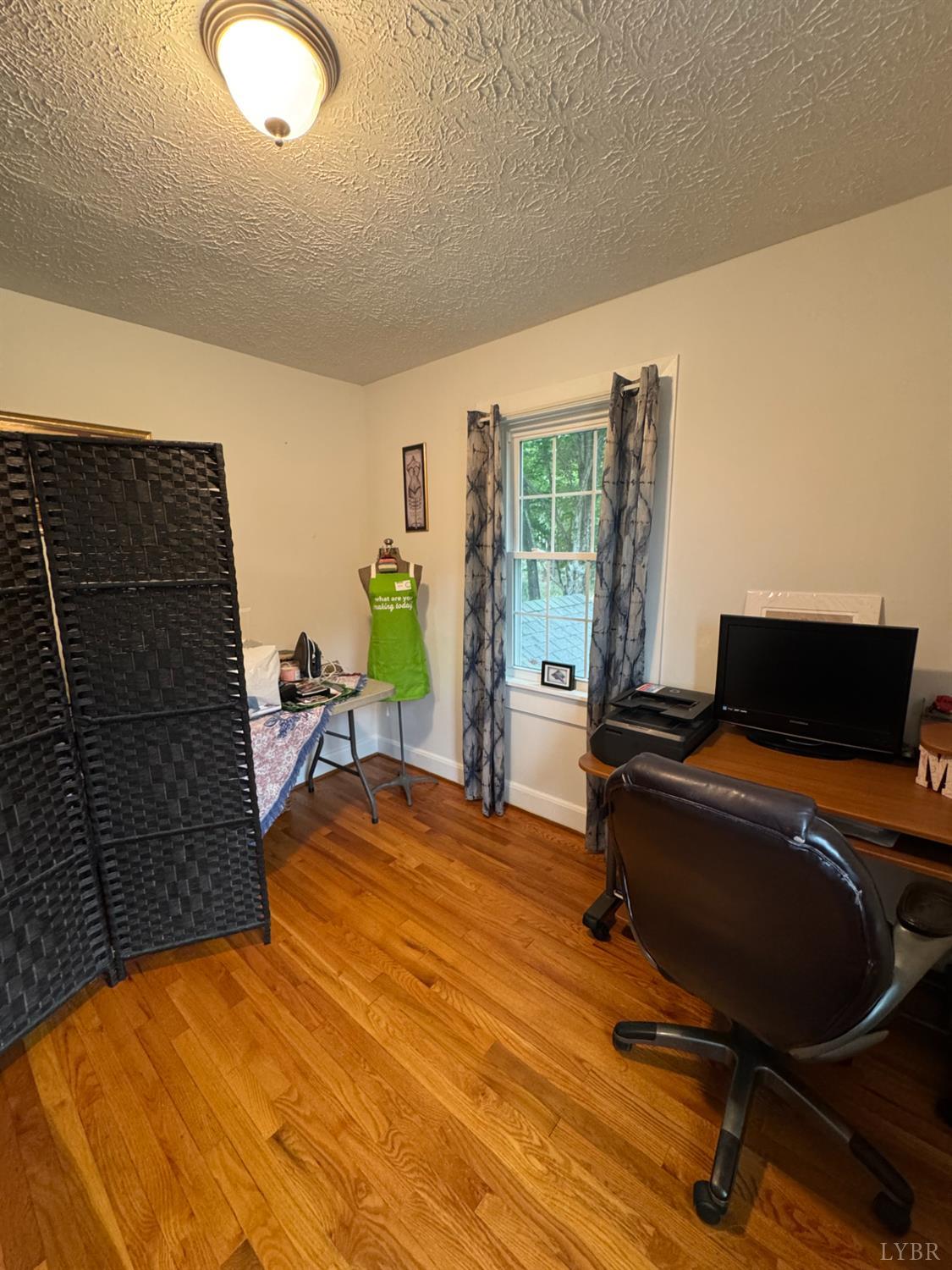 100 New Chapel Road Rustburg, VA 24588 - Photo 24 of 44 a bedroom with a bed and wooden floor