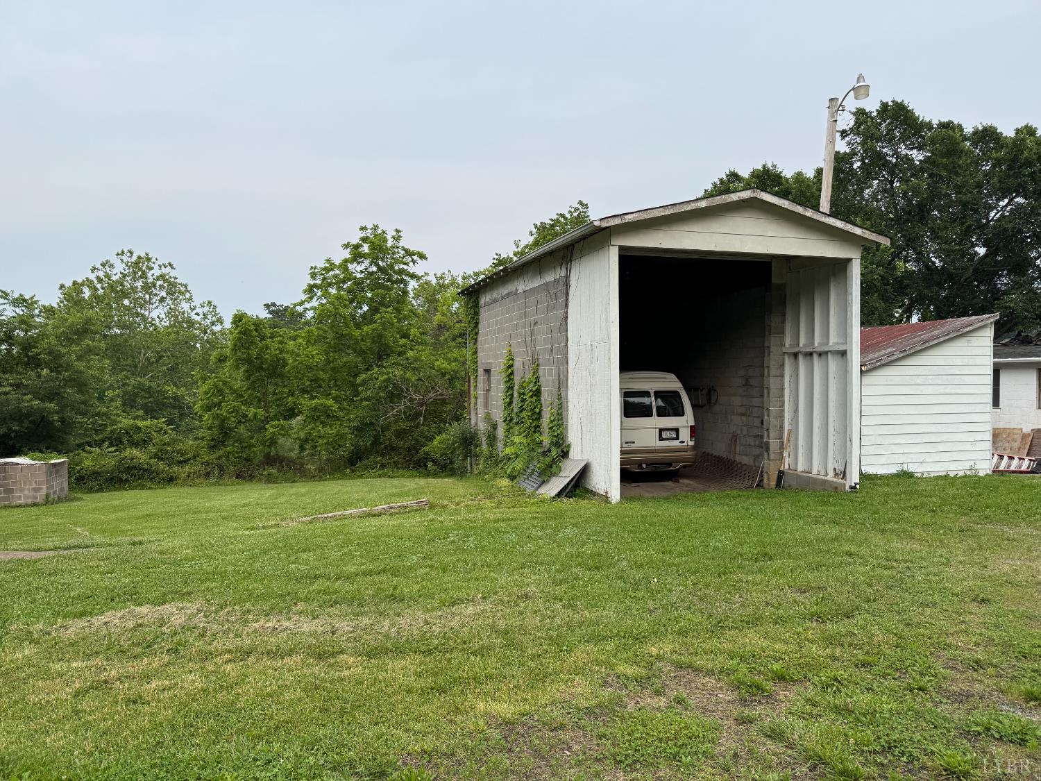 100 New Chapel Road Rustburg, VA 24588 - Photo 44 of 44 a car parked in front of a house with a small yard
