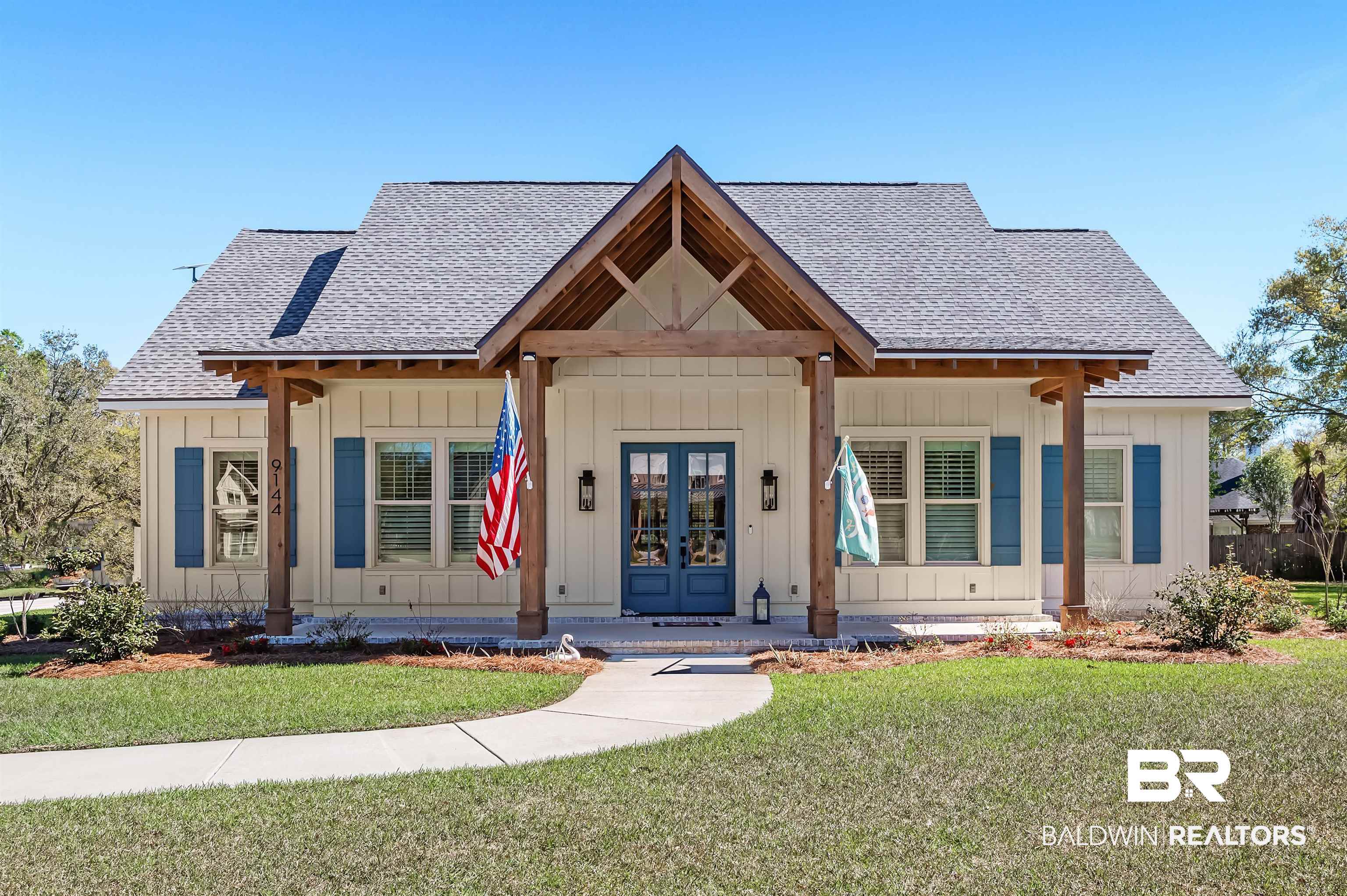 9144 Harvest Ridge Fairhope, AL 36532 - Photo 1 of 58 View of front of home with french doors, board and batten siding, a front yard, and a shingled roof