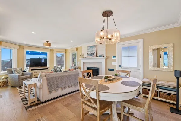 a dining room with furniture a chandelier and wooden floor