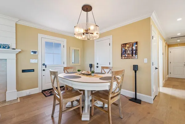 a view of a dining room with furniture and chandelier