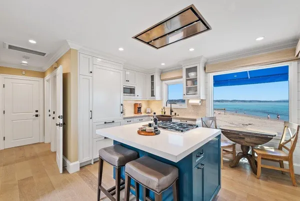 a white kitchen with a table and chairs in it