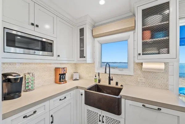 a kitchen with stainless steel appliances a sink a stove a microwave and cabinets