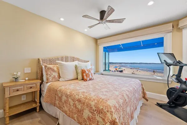 a bedroom with a bed and a ceiling fan