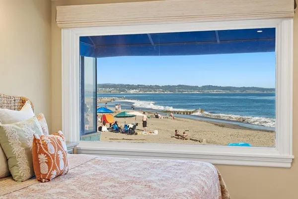 a bedroom with a bed and balcony view