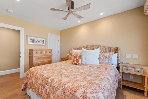 a large bed sitting in a bedroom and a chandelier