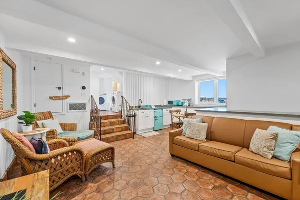 a living room with furniture kitchen view and a table