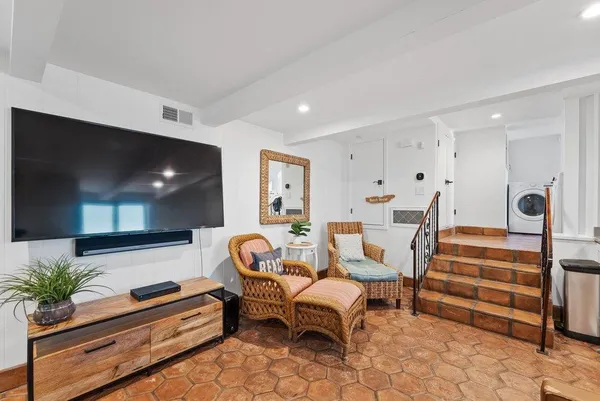 a view of a kitchen area with furniture and wooden floor