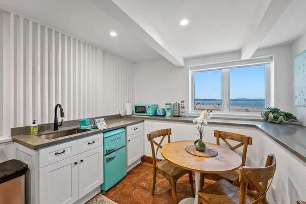 a view of a kitchen island with furniture and wooden floor