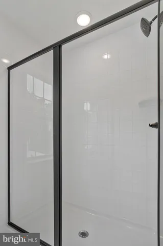 a bathroom with a glass shower door