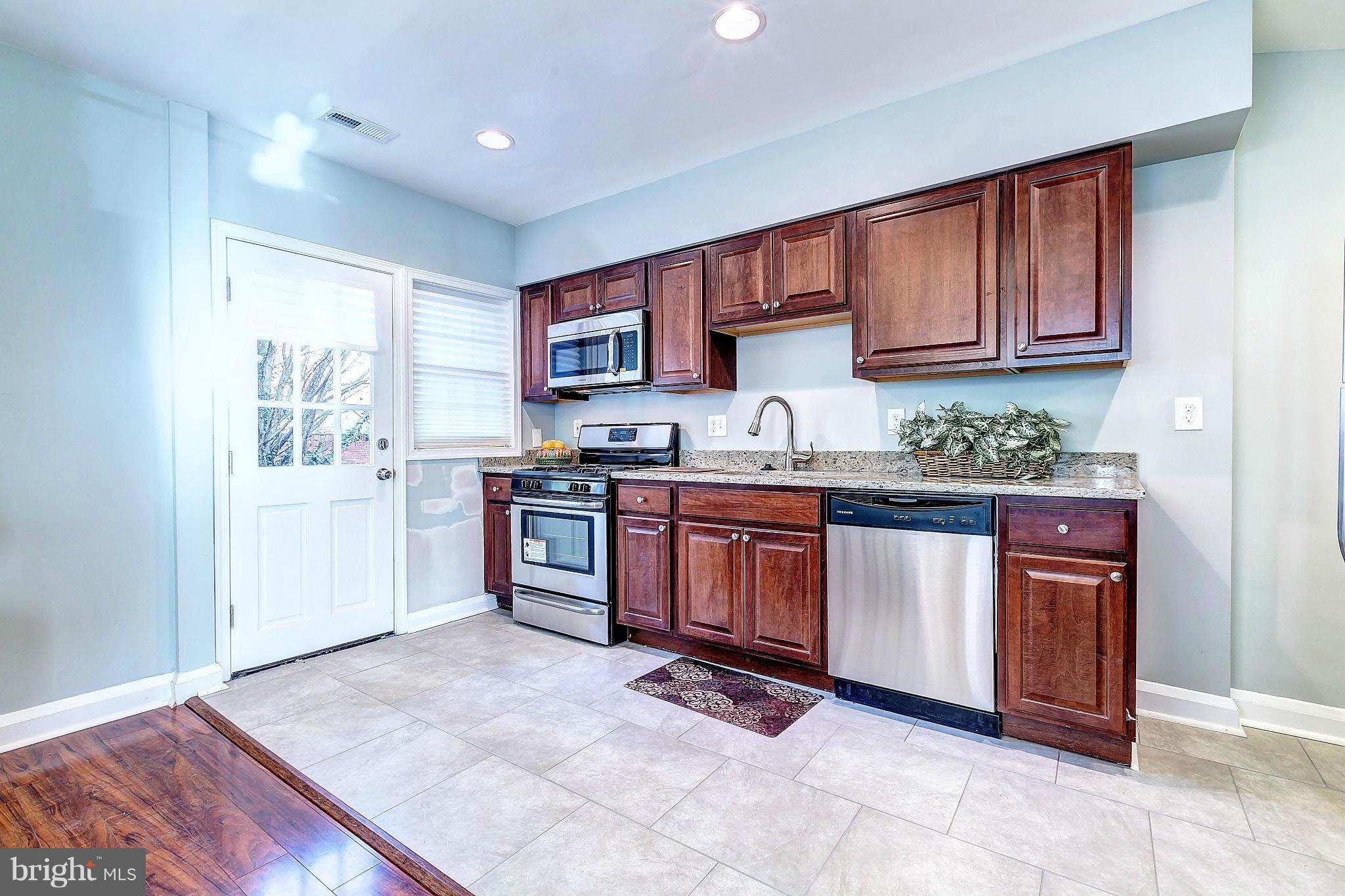 968 North Hill Road Baltimore, MD 21218 - Photo 11 of 29 a kitchen with a sink window and cabinets