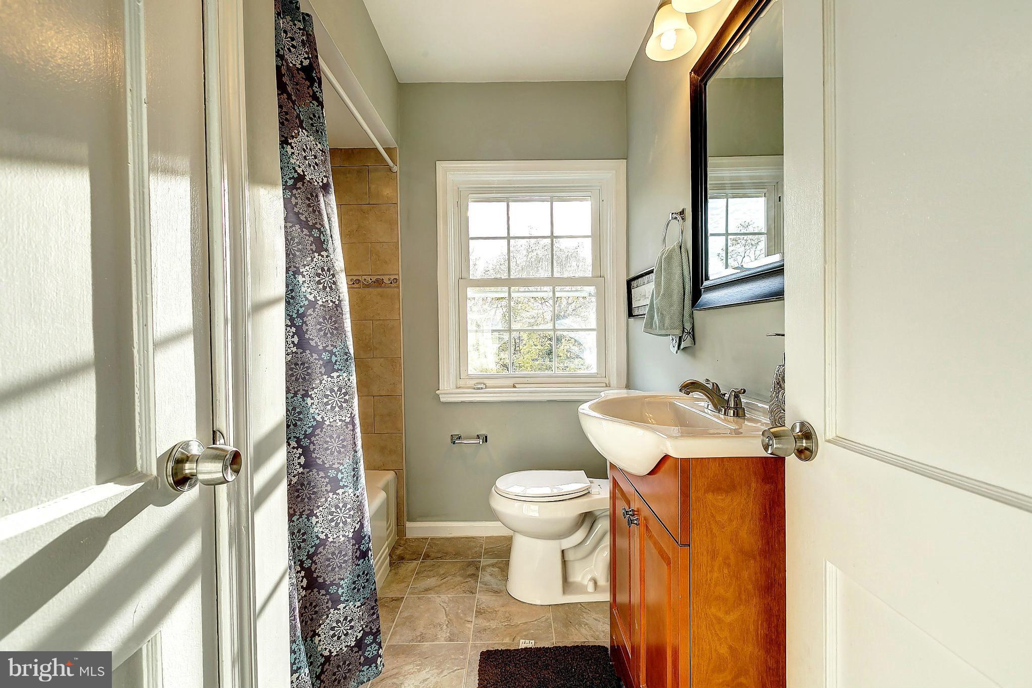 968 North Hill Road Baltimore, MD 21218 - Photo 17 of 29 a bathroom with a sink toilet and shower