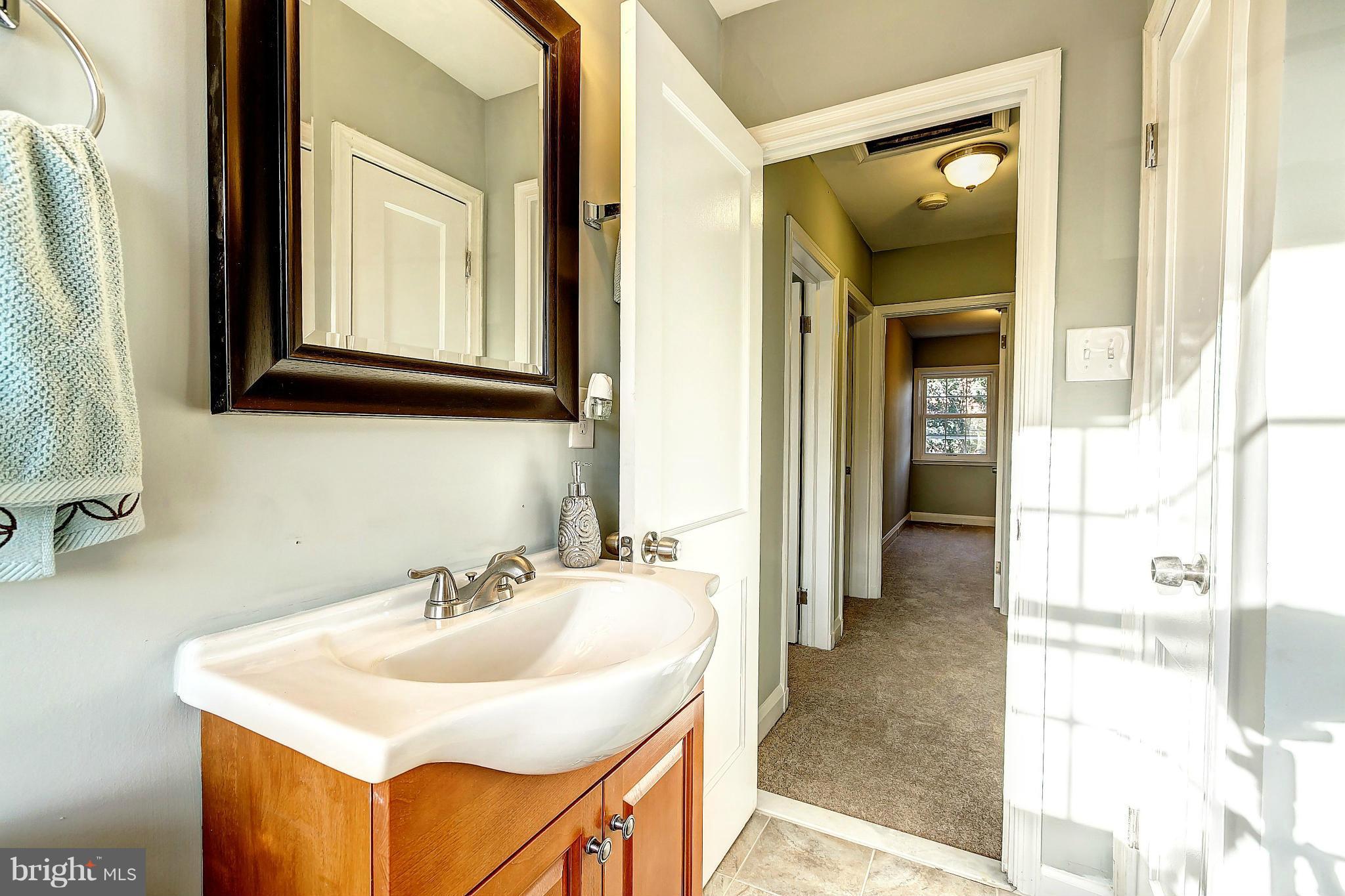 968 North Hill Road Baltimore, MD 21218 - Photo 18 of 29 a bathroom with a sink and a mirror