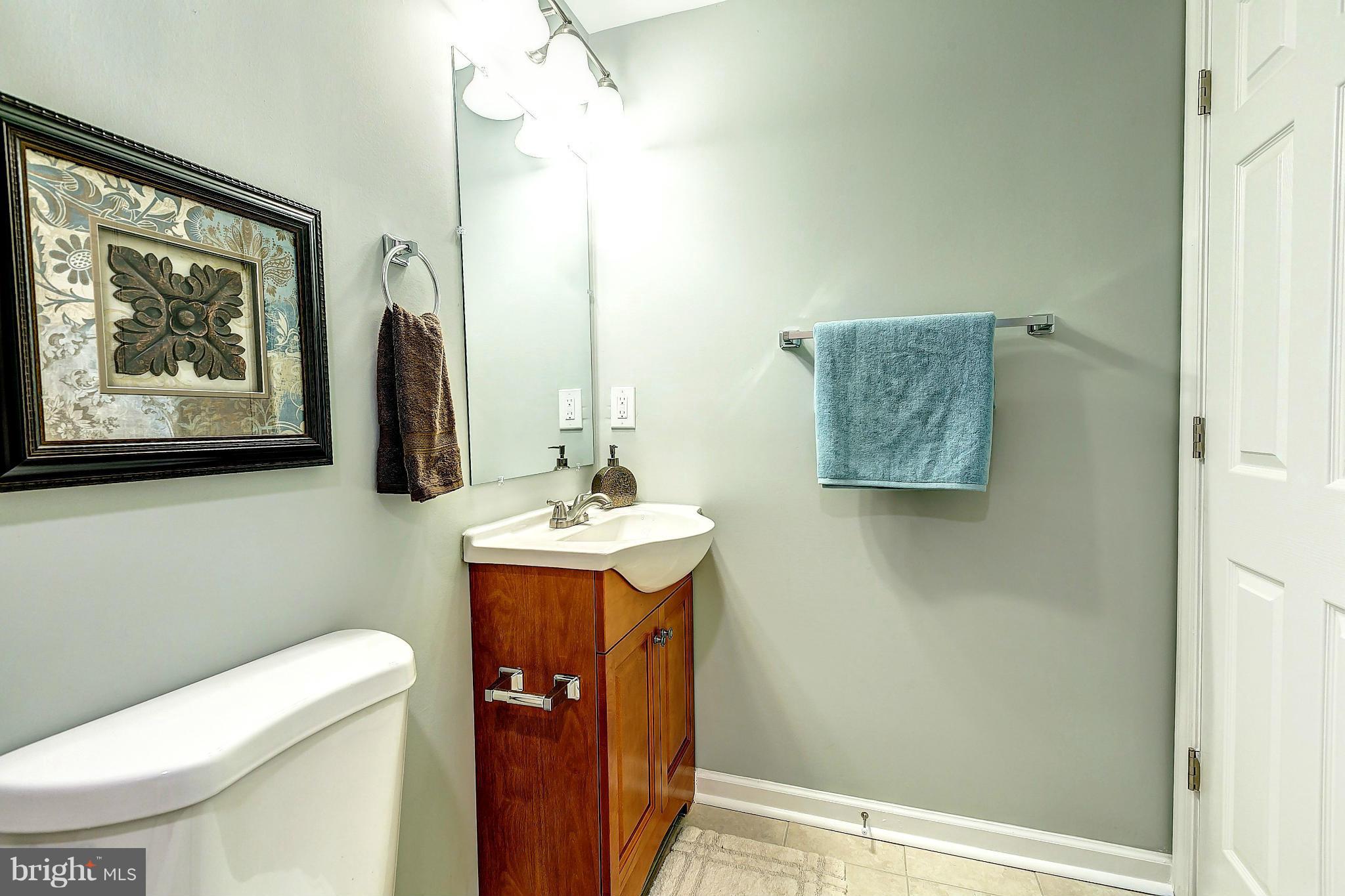 968 North Hill Road Baltimore, MD 21218 - Photo 25 of 29 a bathroom with a toilet a sink and mirror