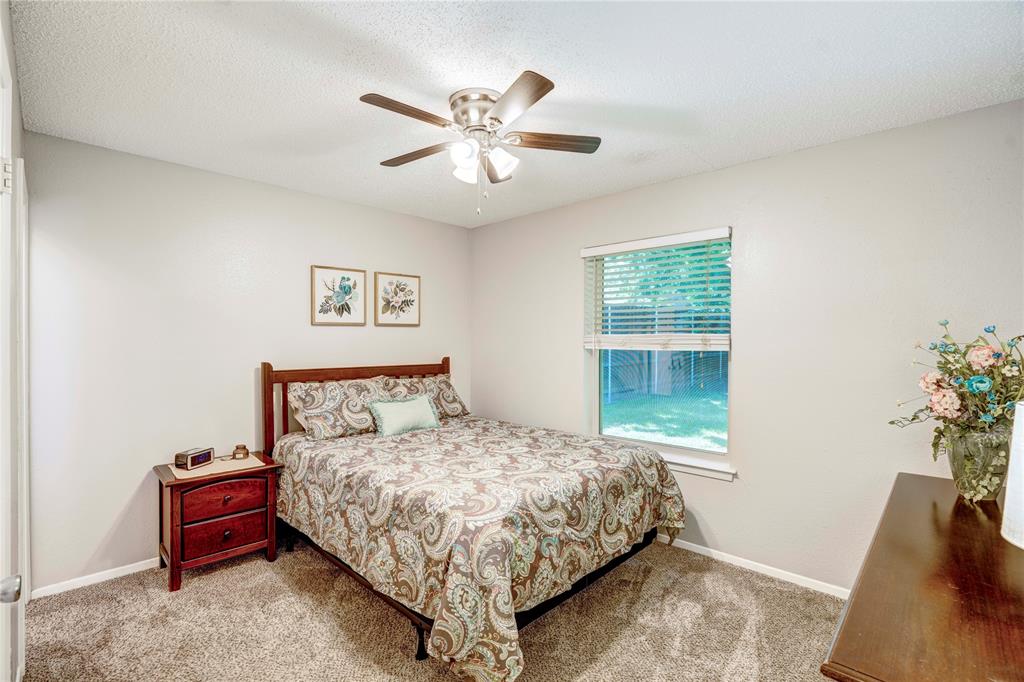 6028 Ridgecrest Drive Watauga, TX 76148 - Photo 17 of 40 a bedroom with a bed and a window