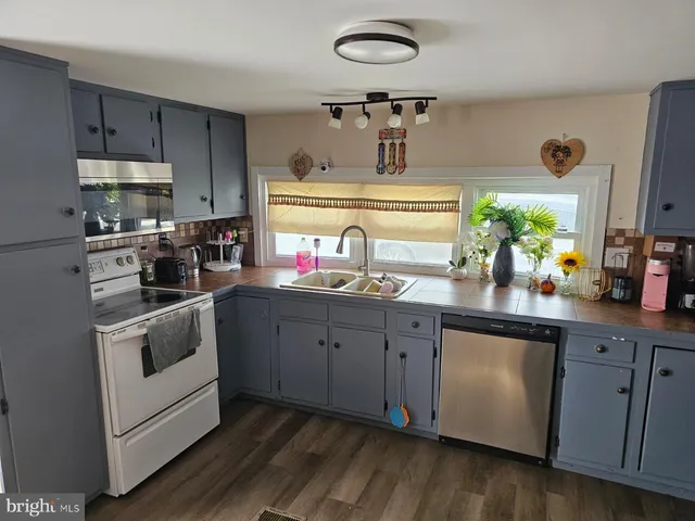 a kitchen with cabinets a sink and appliances