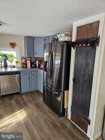 a kitchen with granite countertop a refrigerator and a sink